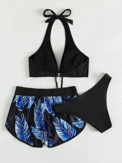 A stylish 3-piece swimsuit set featuring a unique leaf print design, including a top, bottoms, and matching shorts.
