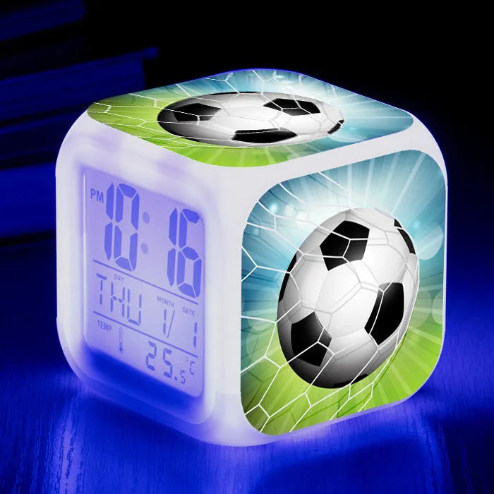 Colourful cartoon football pattern children's mute alarm clock on a table.