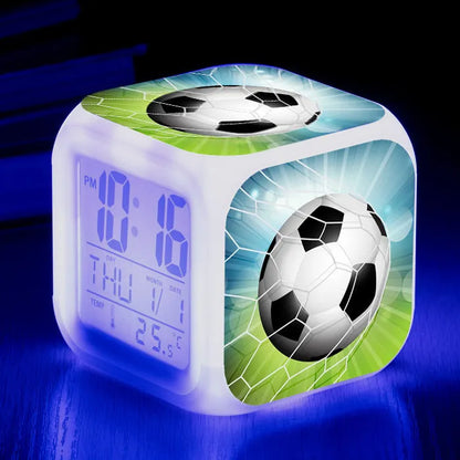 Colourful cartoon football pattern children's mute alarm clock on a table.