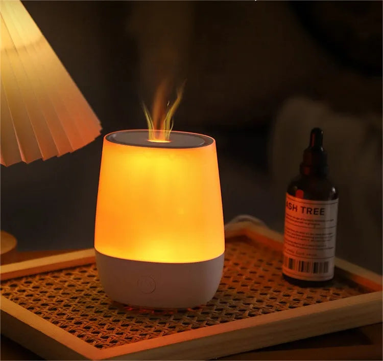 White USB aroma diffuser humidifier with simulated flame light effect on a table.