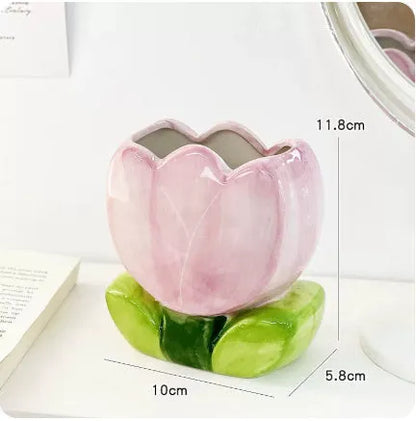 Ceramic floral pen holder showing blue flowers pattern, measuring 11.8cm wide by 10cm high