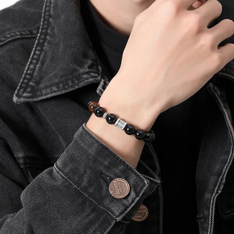 Men's black obsidian prayer wheel bracelet with hand-woven construction and 10mm beads