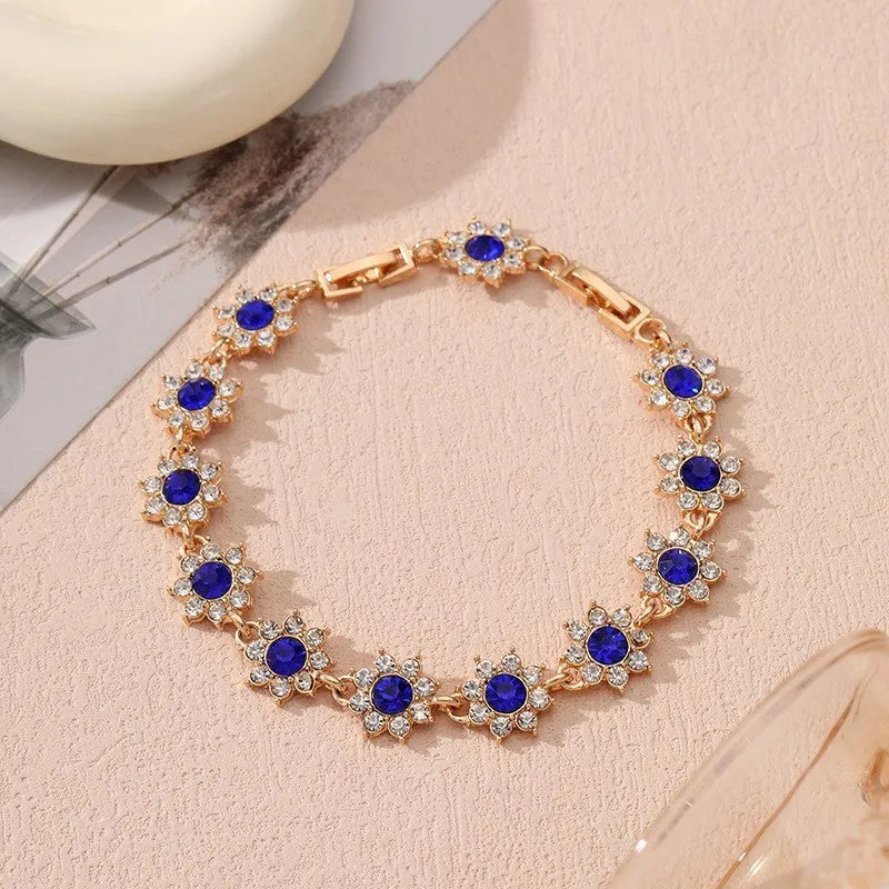 Floral shaped zinc alloy bracelet with electroplated colourful gem finishes in gold and silver tones.