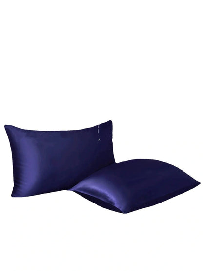 Navy blue floral pattern silk bedding set with quilt cover, fitted sheet, and two pillowcases on bed