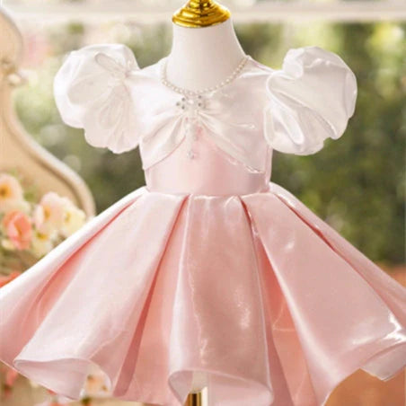 Girls pink puff sleeve princess dress with colour-coordinated design on hanger