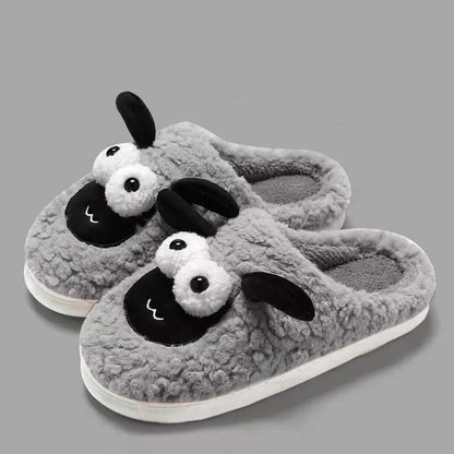 Brown suede slip-on slippers with thermal cotton body and sewn PVC sole on a wooden floor.