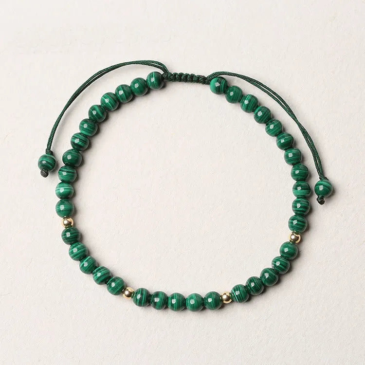 Women's malachite crystal bracelet with golden balls and handwoven design