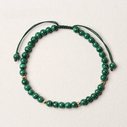 Women's malachite crystal bracelet with golden balls and handwoven design