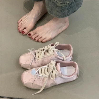 Women's white sneakers with decorative bow and round toe design in beige colour option