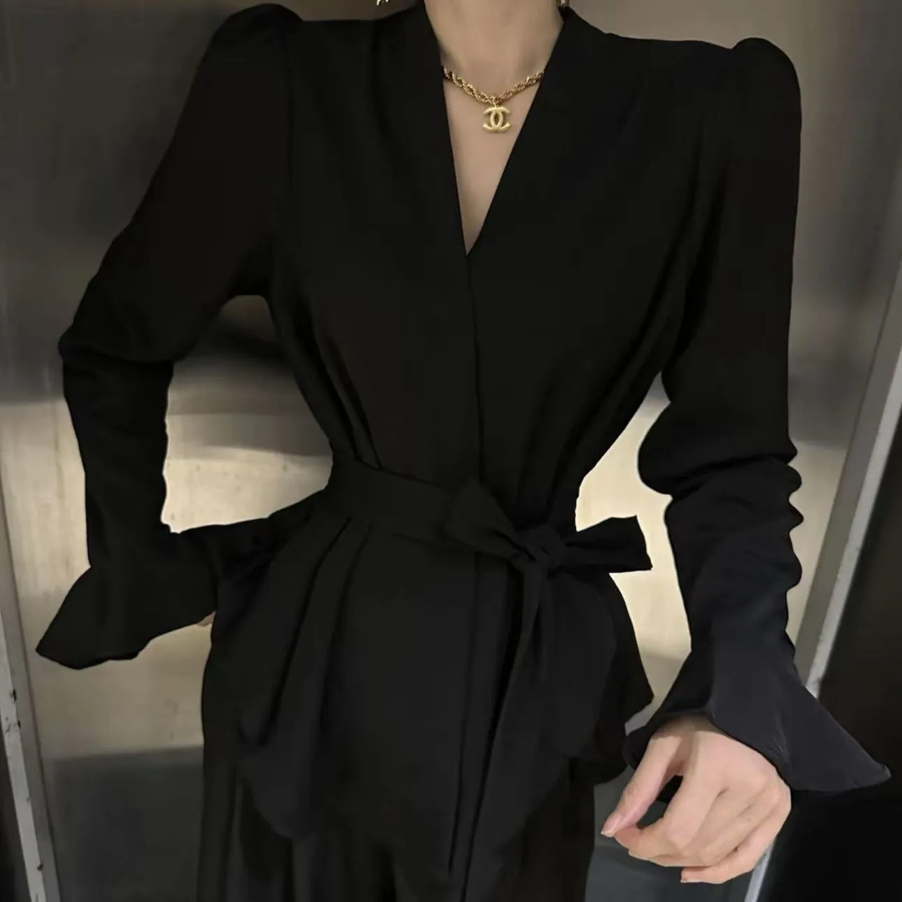 Women's French-style irregular collar long sleeve tied shirt in black with bell sleeves and tied front