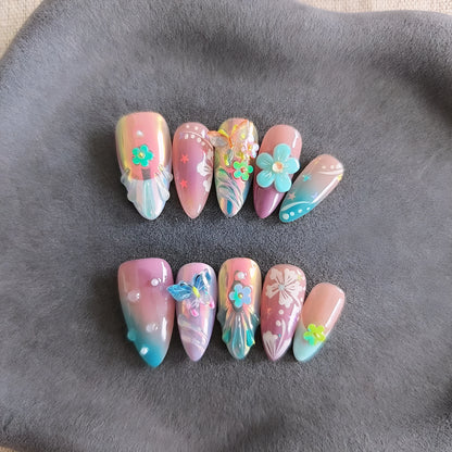 Handmade 3D nail art sculptures showing embossed flowers and butterflies in various sizes on a manicure.