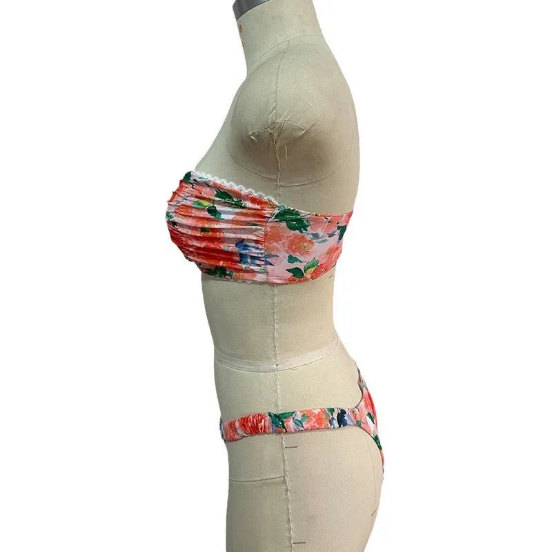 Colourful floral print tube top bikini set with lace trim on a mannequin