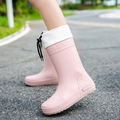 Women's solid colour PVC rain boots with non-slip soles in apricot, black, brown, or pink
