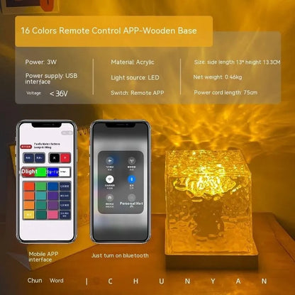 LED water ripple projection night light with remote control on wooden base showing colourful light patterns