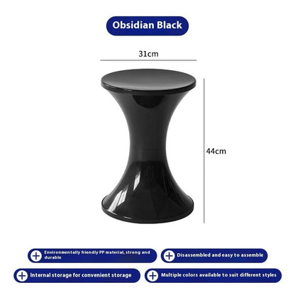 Plastic hourglass-shaped shoe changing stool in green, 40cm high and 30cm wide