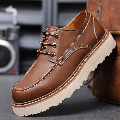 Men's black low-top Martin boots with a round toe and rubber sole on a white background.