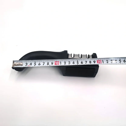 White plastic kitchen knife sharpener measuring 15cm long with special stone sharpening element
