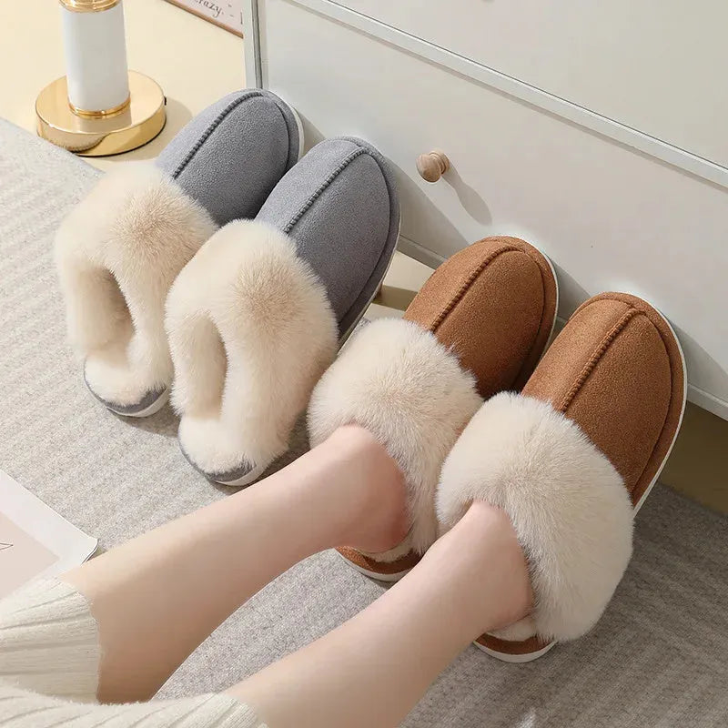 Women's plush indoor slippers in a selection of colours with a fuzzy upper and flat sole.