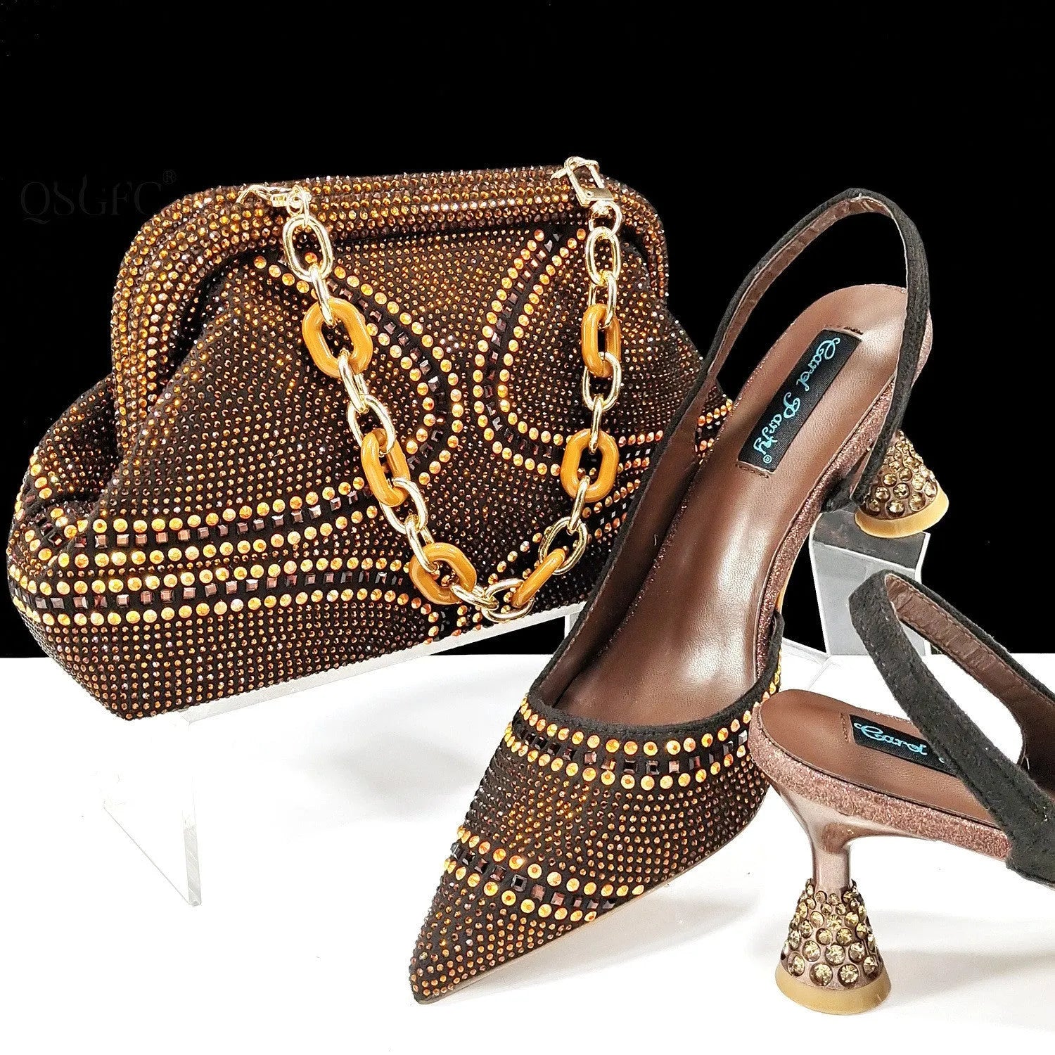 Women's pointed toe high heel court shoes in blue with rhinestone detail and a matching small bag.