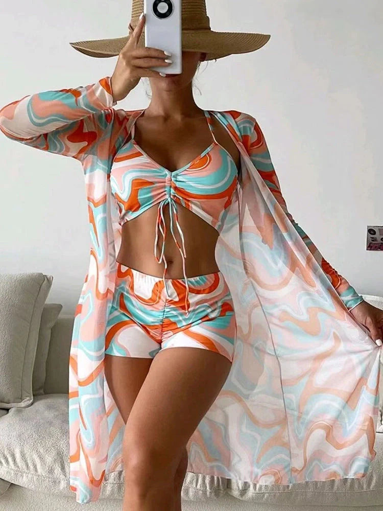 Women's floral print bikini set with long sleeve cardigan for summer beach outings