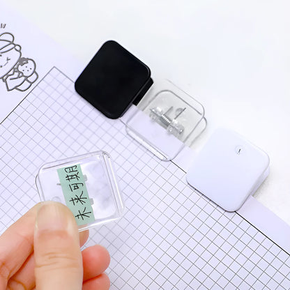 Square plastic photo holder in black, white, and transparent colour options on desk
