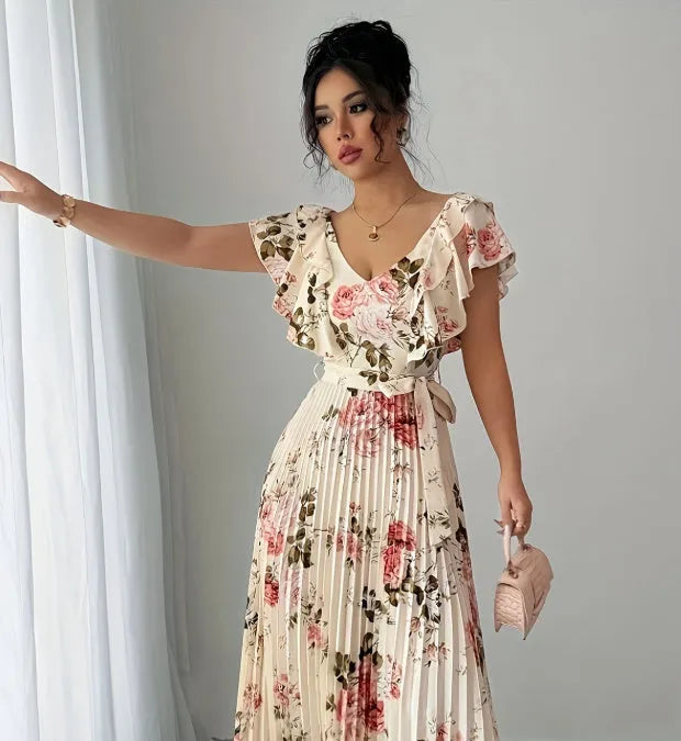 Apricot-coloured V-neck dress with floral print, ruffled short sleeves, high waist, and a long, pleated swing skirt.