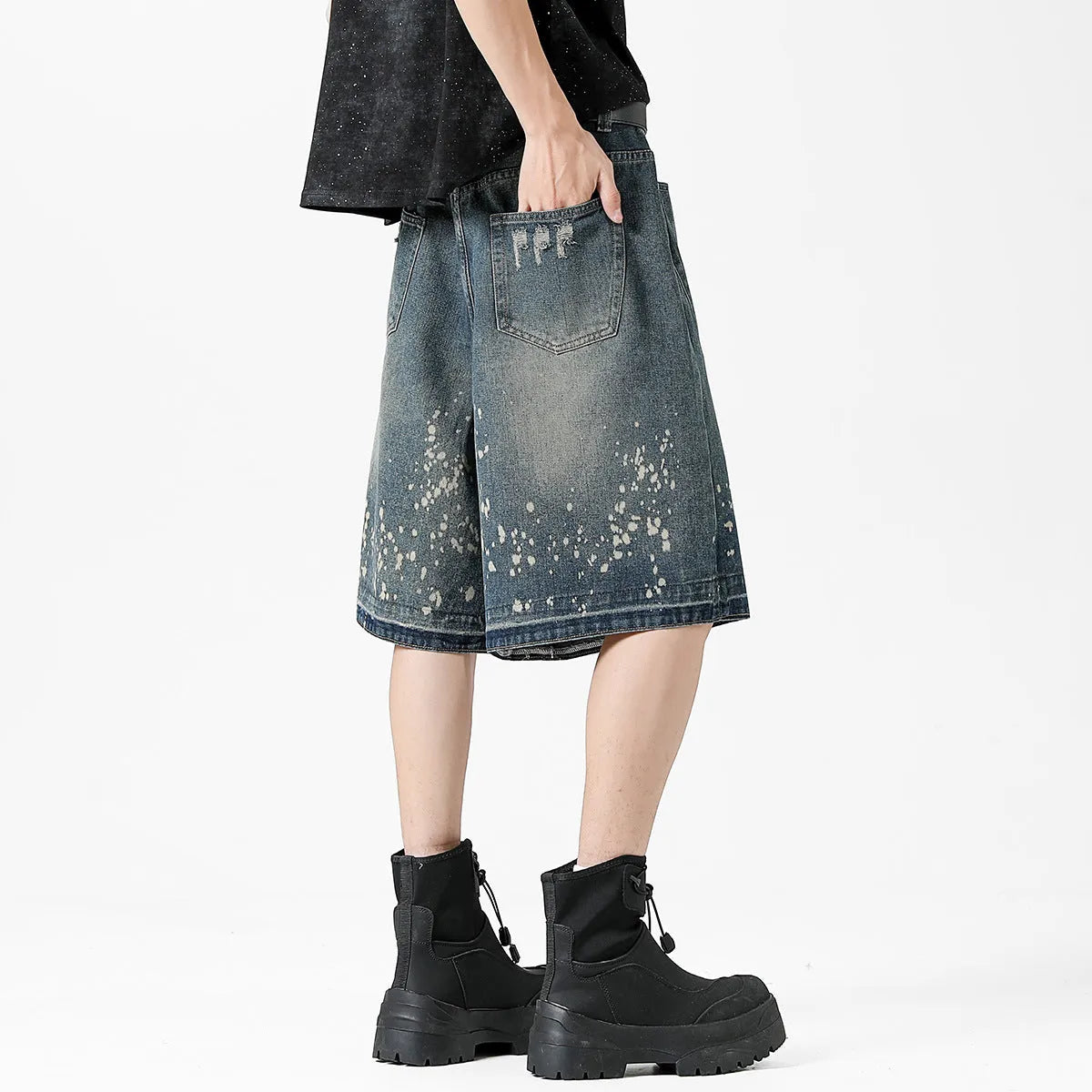 Retro blue denim shorts for men with ripped details and splash ink pattern on a straight cut.