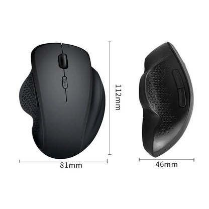 Compact grey wireless mouse with USB charging cable on a wooden desk next to a laptop.