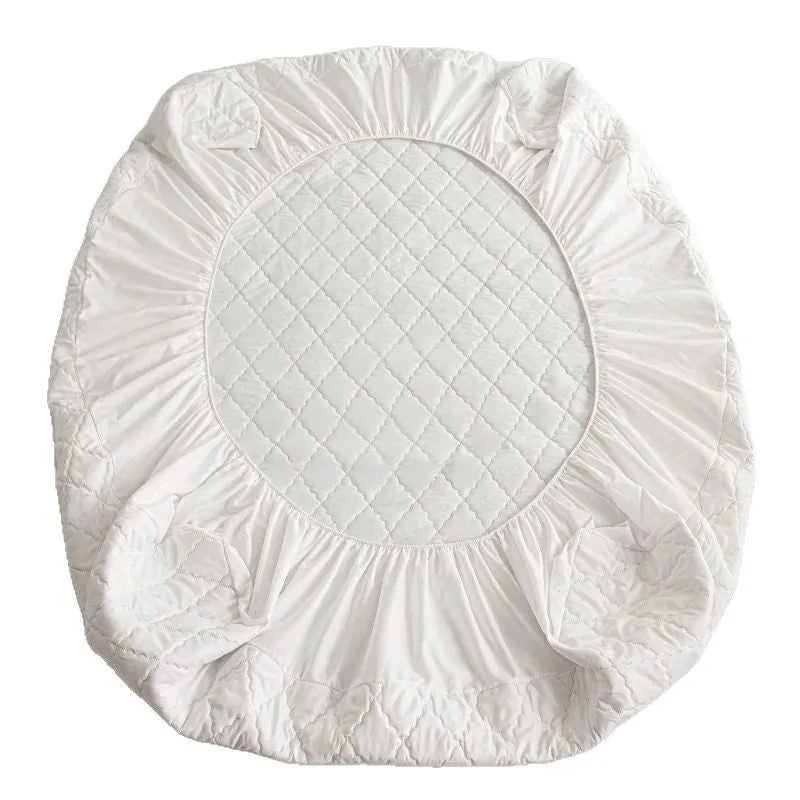 Diamond lattice quilted bamboo fibre mattress protector set in solid colour on a bed.