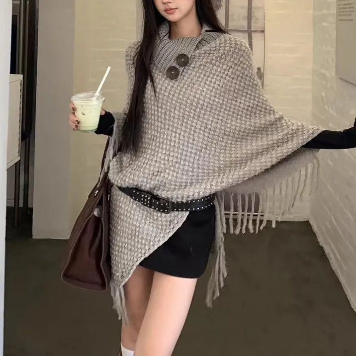 Women's triangle shawl cape in cashmere blend fabric with tassel details, shown draped over shoulders