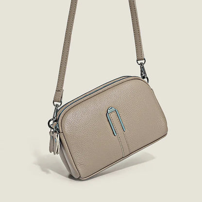 Minimalist top-grain leather crossbody bag in horizontal square shape with inner pockets, available in five colours