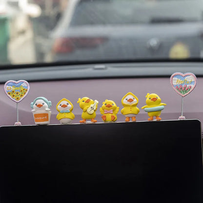 Set of six small yellow PVC duckling figures and one rectangular 'Hello' sign for car interior decoration