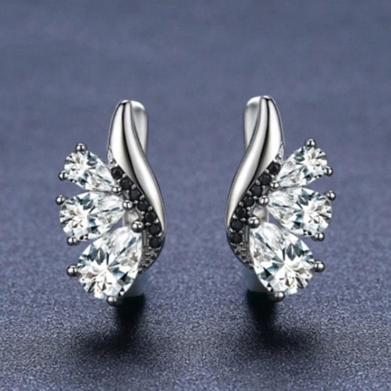 Elegant wing-shaped earrings with drop-shaped zircon stones, crafted with copper for a sophisticated and fashionable look