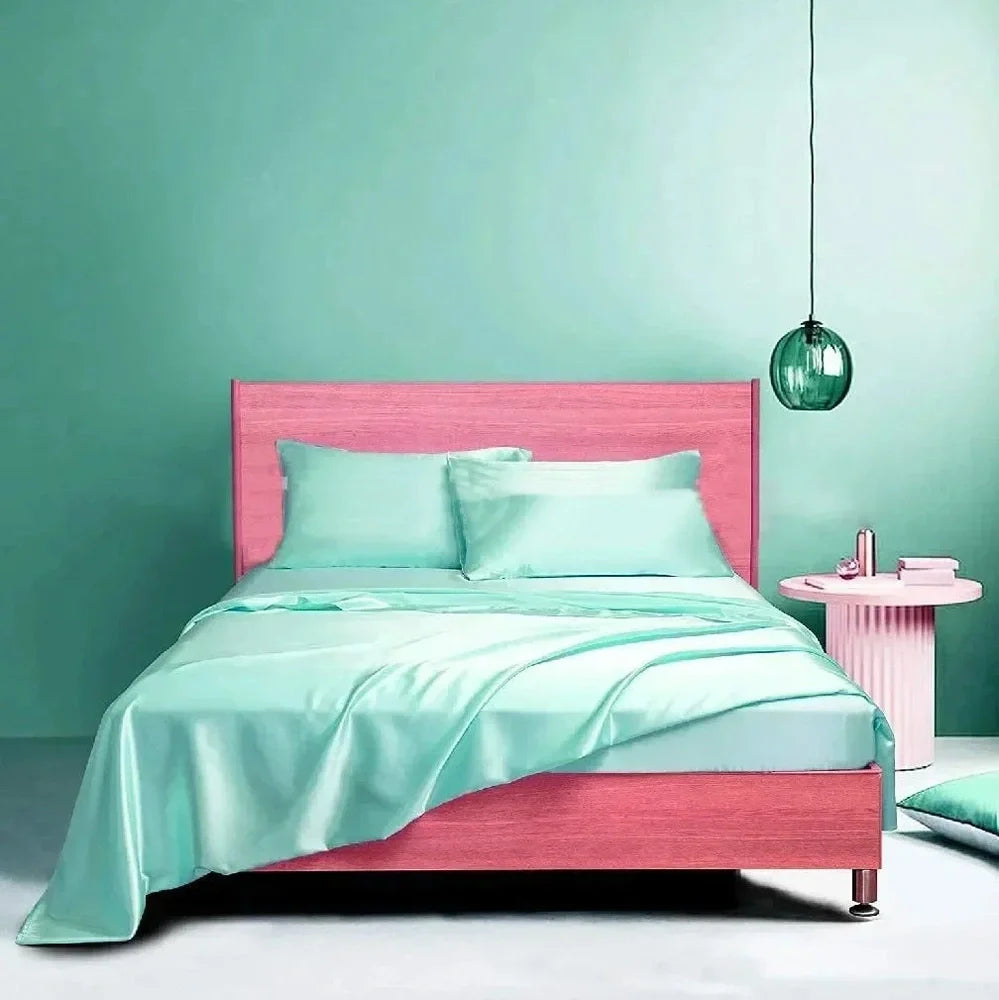 Navy blue floral pattern silk bedding set with quilt cover, fitted sheet, and two pillowcases on bed