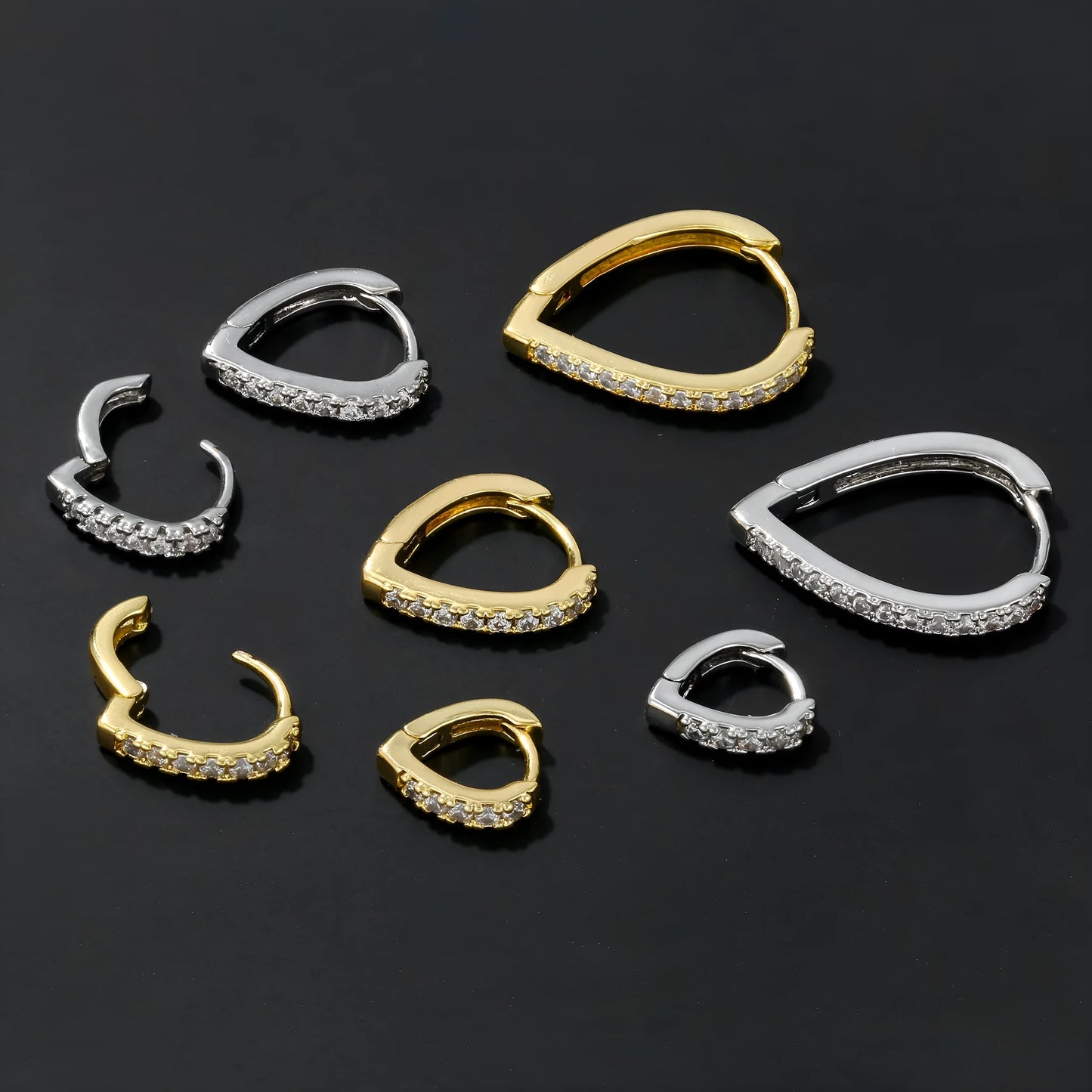 Copper geometric heart ear clip with electroplated finish in gold and white colour options on earlobe