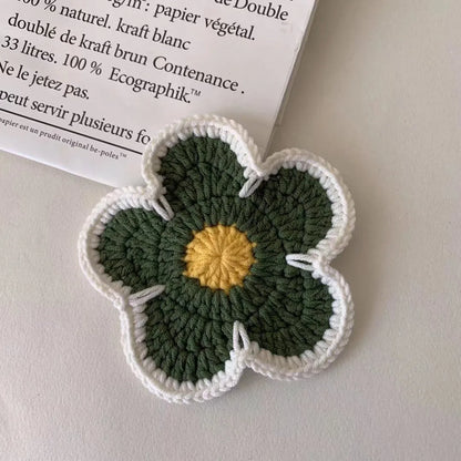 Five handmade woven flower placemats in blue, green, orange, pink and purple colours