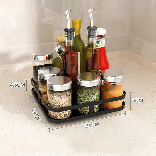 Stainless steel rotating spice rack with two tiers holding 12 bottles on kitchen countertop