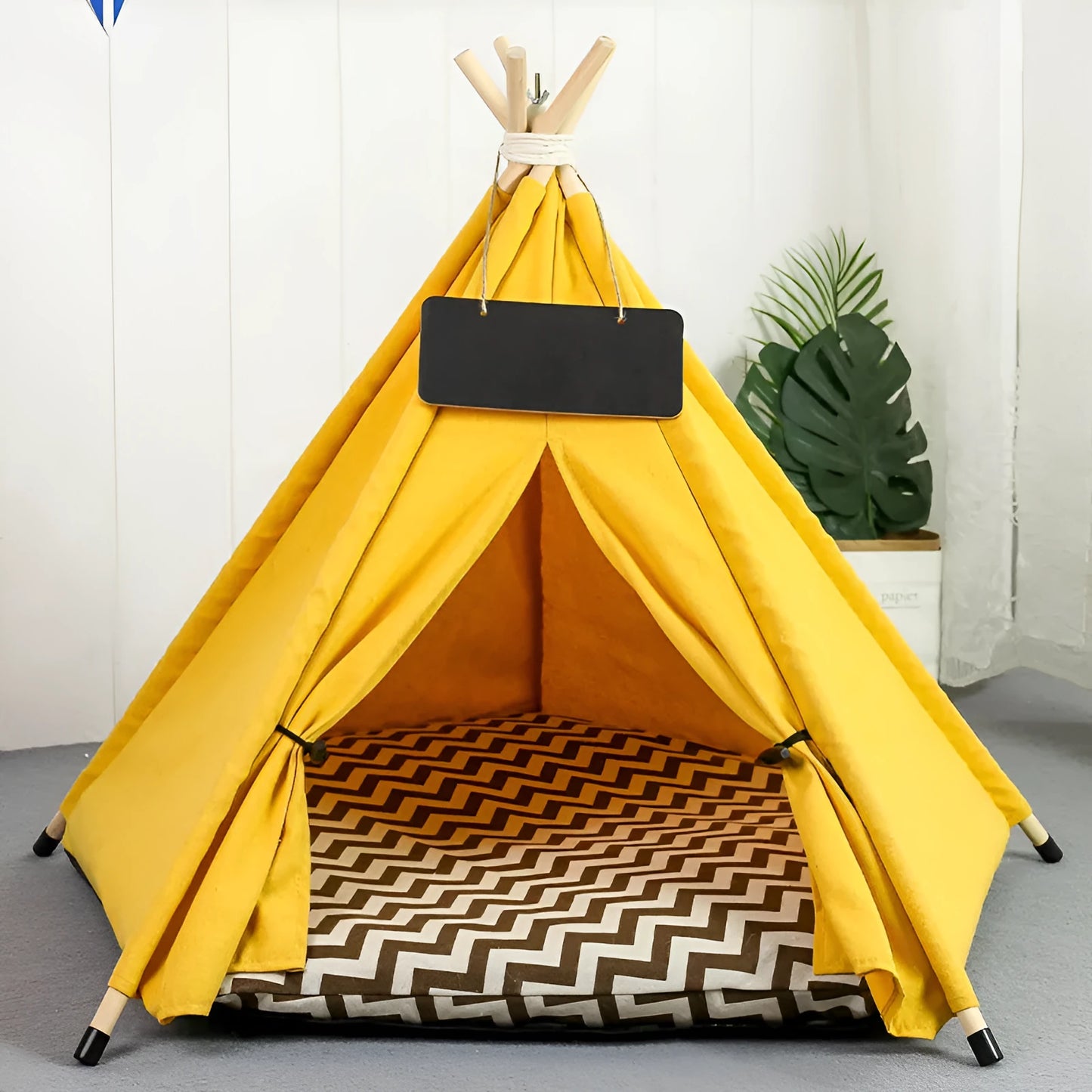A striped pet teepee tent bed with a cushion inside, shown in a yellow colour option.