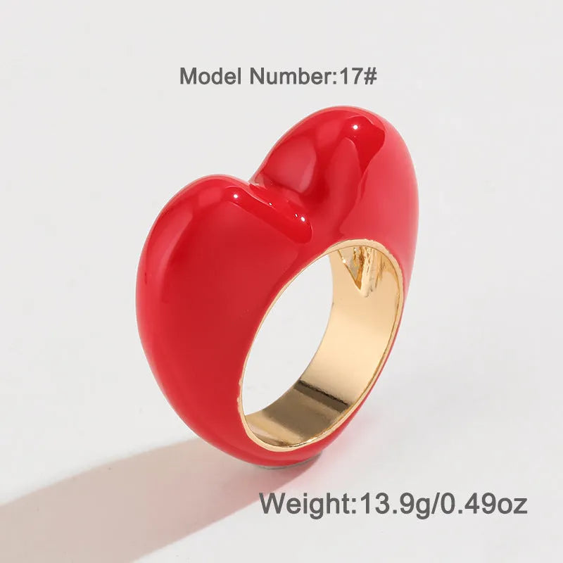Heart-shaped enamel ring with three-dimensional detail in black, pink, purple, or red, sized for fingers 17-18