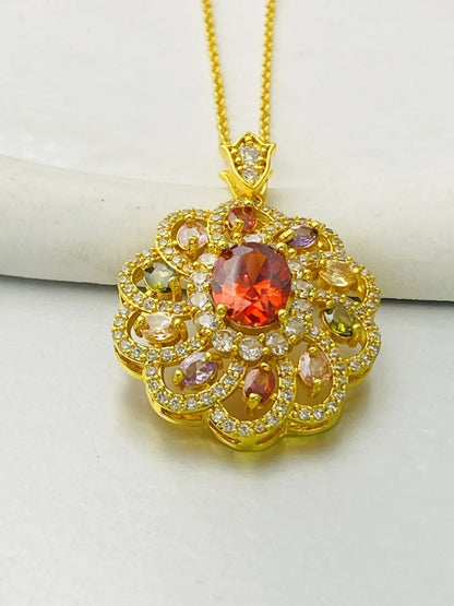 Close-up of a women's gold-coloured flower pendant necklace with a bright zircon stone centre.