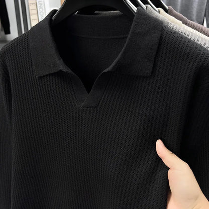 Man wearing a loose fit camel coloured pullover sweater, a casual autumn layer with a simple design.