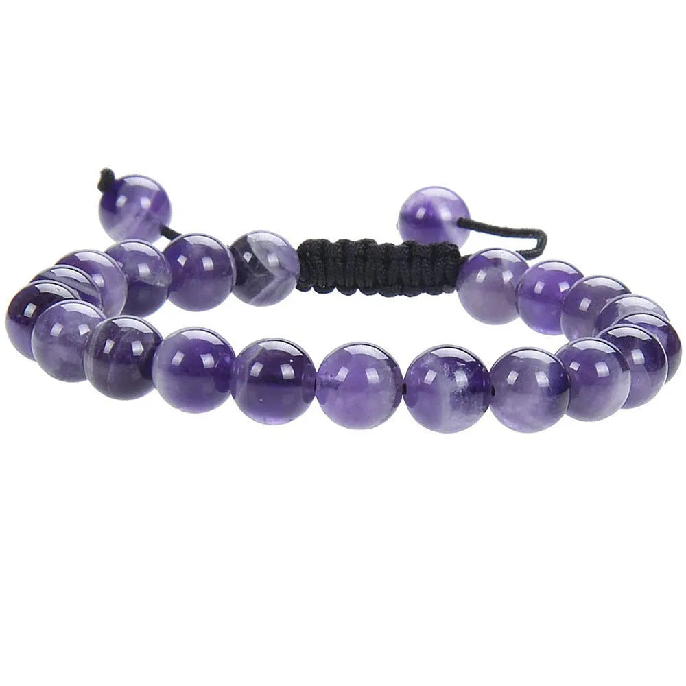 Close-up of a women's flat knot braided healing bracelet hand-woven with colourful gemstones.