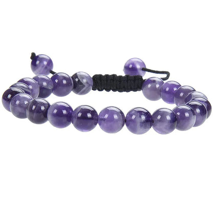 Close-up of a women's flat knot braided healing bracelet hand-woven with colourful gemstones.