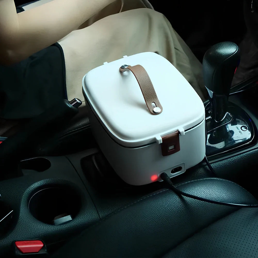 White car heating lunch box with stainless steel interior showing power cords and utensils