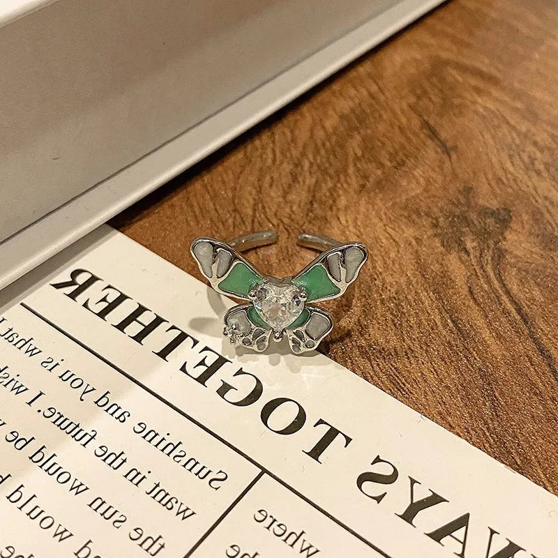 Copper women's ring with Chinese butterfly design and adjustable open loop.