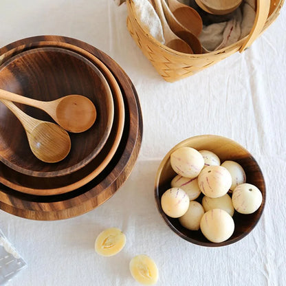 Brown handmade wooden serving bowl with natural wood grain on a table.