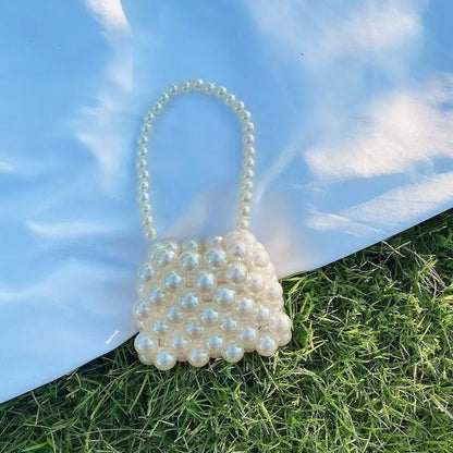 Women's imitation pearl mini crossbody handbag with geometric pattern in a pearl colour.