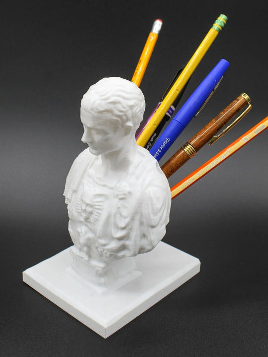 White American character modelling pen holder measuring 12cm tall on desk