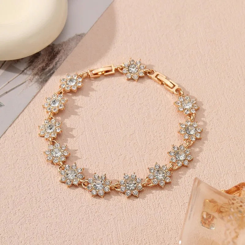 Floral shaped zinc alloy bracelet with electroplated colourful gem finishes in gold and silver tones.