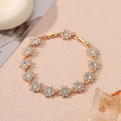 Floral shaped zinc alloy bracelet with electroplated colourful gem finishes in gold and silver tones.